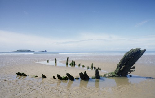 WALES, Gower Peninsula, Rhossili Bay , Helvetia 1890’s shipwreak. Oak carcass on sandy beach at low