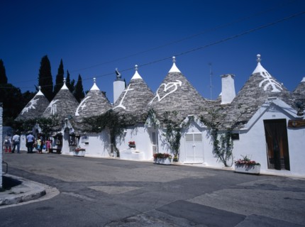 ITALY, Puglia, Bari Provence, "White Trulli buildings with runic symbols painted on the grey stone