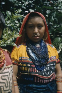 COLOMBIA, Arquia, Cuna Tribe, "Girl wearing glass bead necklace and typical bead amulets. She also