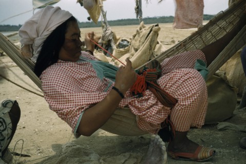 COLOMBIA, Guajira Peninsula, Guajiro / Wayuu Tribe, Wayuu woman sews a coloured “faja” / woven