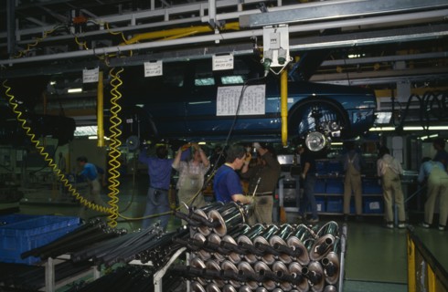 GERMANY, Sachsen, Workers on factory floor of Volkswagen production plant.