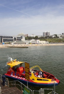 ENGLAND, Dorset, Bournemouth, Speed Boat ride from the Pier with The East Beach and the Imax