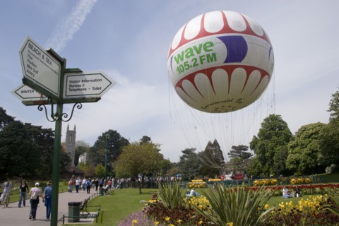 ENGLAND, Dorset, Bournemouth, The Bournemouth Eye balloon lifting off in The Upper Pleasure Gardens