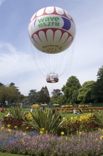 ENGLAND, Dorset, Bournemouth, The Bournemouth Eye balloon lifting off in The Upper Pleasure Gardens