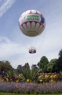 ENGLAND, Dorset, Bournemouth, The Bournemouth Eye balloon lifting off in The Upper Pleasure Gardens