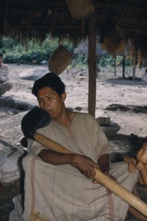 COLOMBIA, Sierra de Perija, Yuko - Motilon ., "Headman playing beeswax axe-head flute, the body