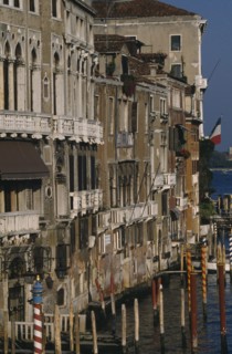 ITALY, Veneto, Venice, The Grand Canal.  Waterside buildings and gondola moorings from the Rialto.