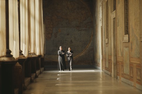 ITALY, Lazio, Rome, Vatican City.  Clerics in discussion walking along loggia beside Secretariat of