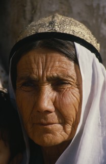 CHINA, Xinjiang, Kashgar, Portrait of an old woman at the Sunday market. Wearing a white head scarf
