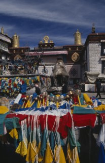 CHINA, Tibet, Lhasa, Prayer wheels and other religious paraphernalia for sale in front of the