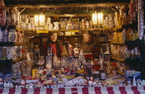 GERMANY, Bayern, Nuremberg, "Women vendors in decorated stall in Christmas market selling