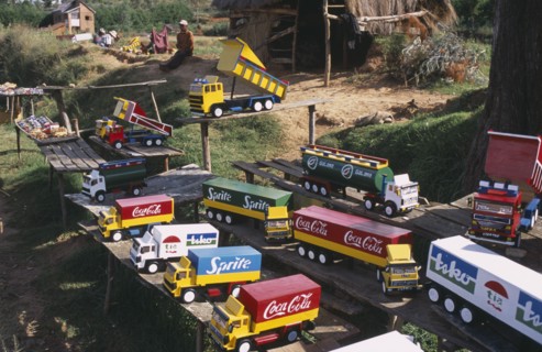 MADAGASCAR, Markets, Road to Antsirabe. Colourful toy vehicles made from locally grown balsa wood