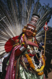 INDIA, Kerala, Thrissur, "Mayura Nritham, Peacock Dance, dancer in costume and painted face, at The