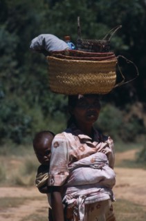 MADAGASCAR, People, Women , Near Ambositra. Portrait of a woman carrying a baby in a sling on her