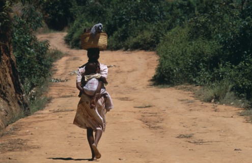 MADAGASCAR, People, Women, Near Ambositra. Portrait of a woman carrying a baby in a sling on her