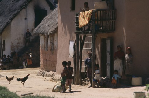 MADAGASCAR, People, Road to Ranomanfana. Women and children in village with thatched huts and