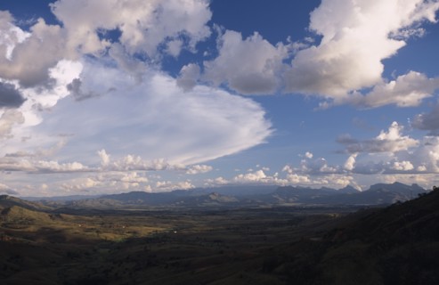 MADAGASCAR, Landscape, Road to Isalo. View across mountain range with a dramatic cloud formation