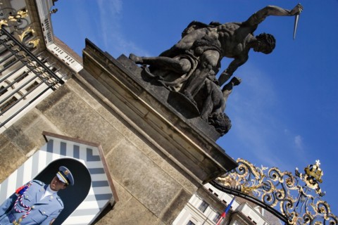 CZECH REPUBLIC, Bohemia, Prague, Soldier standing guard at a sentry box below an 18th Century
