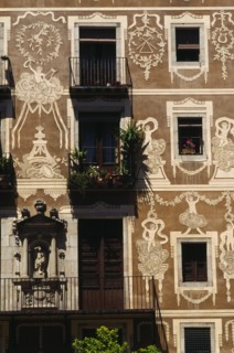 SPAIN, Catalonia, Barcelona, Decorated exterior of flats on the Plaza Delfi with potted plants and