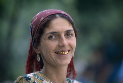 TAJIKISTAN, People, "Portrait of a woman with a dark red head scarf, earrings and gold teeth"
