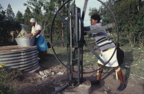 SOUTH AFRICA, Kwazulu Natal, Women drawing water for washing at well.