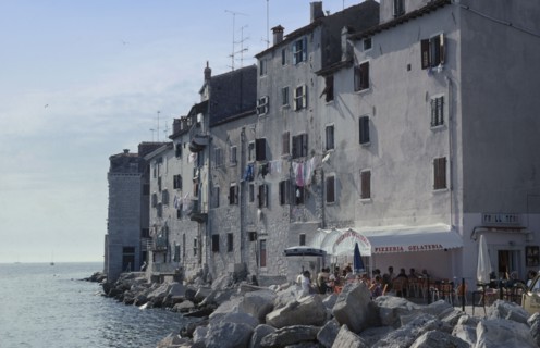 CROATIA, Istria, Rovinj, Old city waterfront building with a washing line hanging from shuttered