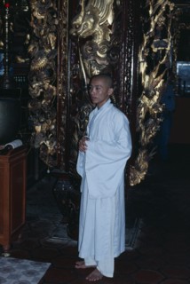 VIETNAM, Mekong Delta, My Tho, Monk wearing white robes in Vinh Trang Pagoda