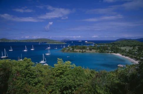 DOMINICA, Landscape, Elevated view over beach and coastline with tree covered Islands and bays on