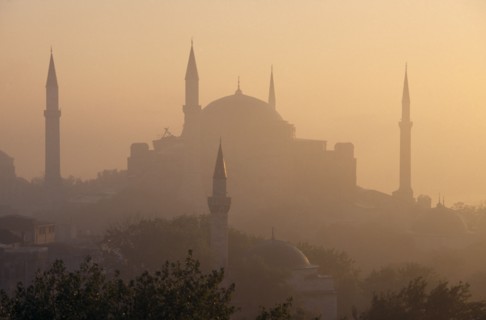 TURKEY, Istanbul, "Dome and minarets of Haghia Sophia silhouetted against hazy, pale orange sky
