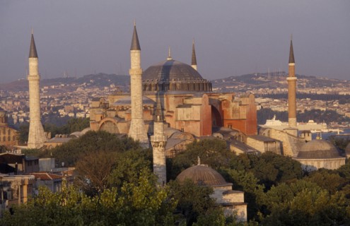 TURKEY, Istanbul, Dome and minarets of Haghia Sophia amongst rooftops of the Sultanahmet.  Former