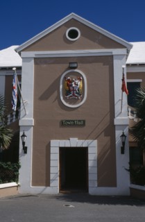 BERMUDA, St George, Kings Square. Town Hall exterior with crest above door  entrance and flagpoles