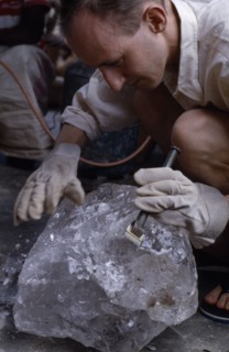 MADAGASCAR, Industry, Quartz dealer examining a crystal
