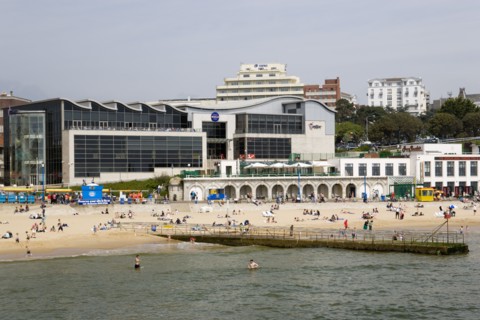 ENGLAND, Dorset, Bournemouth, The Imax Complex on the seafront with people on the beach and in the