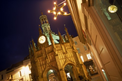 ENGLAND, West Sussex, Chichester, Angled view of The Cross at night  with star shaped Christmas