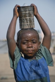 GUINEA, Kissidougou Camp, Little girl with braided hair at camp for refugees from Sierra Leone