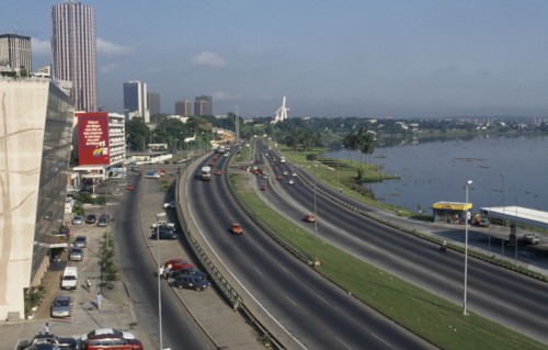 IVORY COAST, Abidjan, "Cityscape with multi lane traffic, skyscrapers and distant view towards