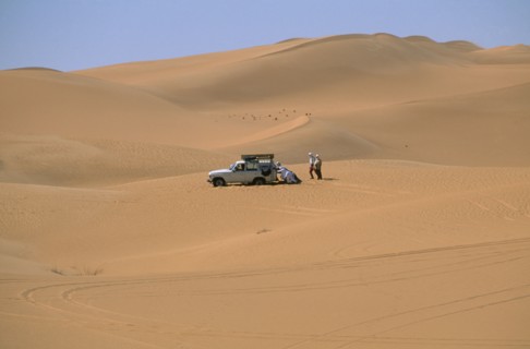 LIBYA, Sahara Desert, Tourists four by four vehicle stuck in Saharan sand.
