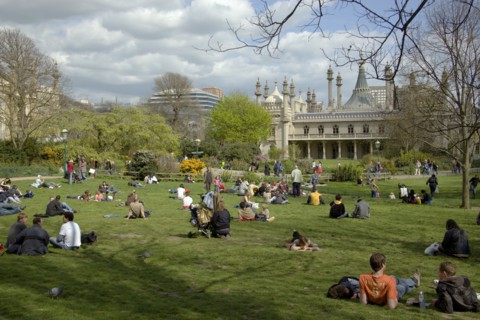 ENGLAND, East Sussex, Brighton, The Royal Pavilion gardens with people relaxing in the spring