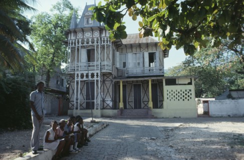 HAITI, Achitecture, Typical domestic architecture.  Colonial style home with children sitting