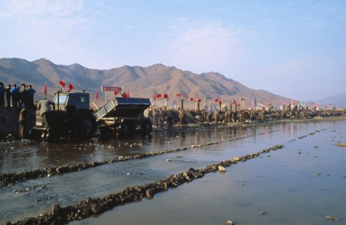 NORTH KOREA, North Hwanghhae Province, Pyongsan County, Juche people in a line reparing flood dykes