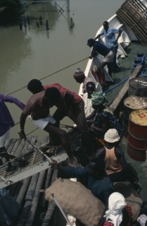 GAMBIA, Transport, People boarding boat on the River Gambia.