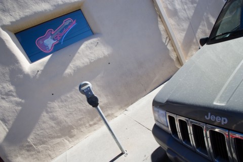 USA, New Mexico, Santa Fe, Illuminated Budweiser sign and electric guitar in window of Blues Club