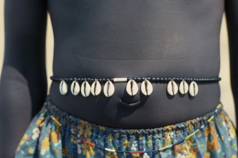 SUDAN, Tribal People, Cropped shot of Dinka girl wearing cowrie shell belt to indicate puberty.
