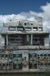 MADAGASCAR, Art, Part view of Mahafaly highly decorated tomb with carved effigy of aeroplane on