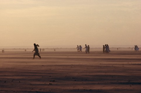 WESTERN SAHARA, SADR, People moving across desert landscape.
