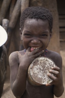 GHANA, North, People, Portrait of small child pulling face with fingers in mouth.
