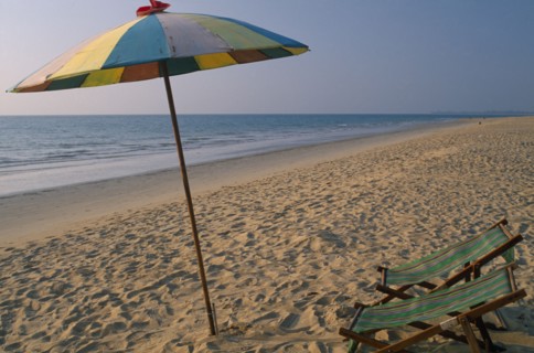 THAILAND, North Phuket, Takua Pa district, "Khao Lak, A multi coloured parasol and two deck chairs