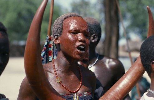 SUDAN, Tribal People, Dinka girl with red painted face at festival celebrating the return of cattle