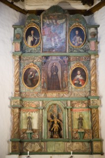 USA, New Mexico, Santa Fe, The altar panel of the San Miguel Mission church with Spanish an Native