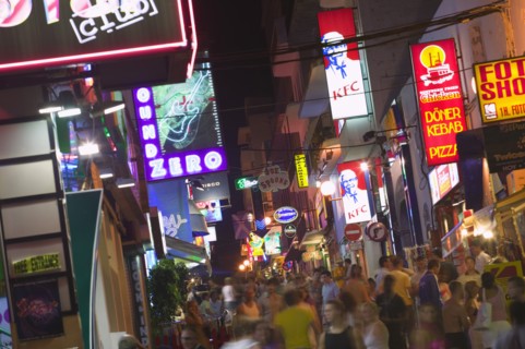 SPAIN, Balearic Islands, Ibiza, "Busy, crowded street in Sant Antonio with neon signs advertising
